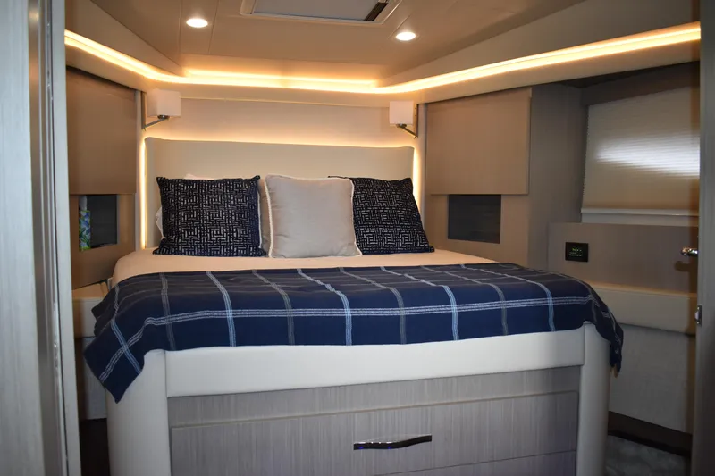 Me Yacht Photos Pics Luxurious bedroom interior of 2021 Regal 42 Fly yacht with modern lighting and cozy bedding.