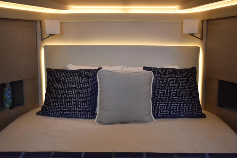 Me Yacht Photos Pics Luxurious bedroom interior of 2021 Regal 42 Fly yacht with elegant lighting and plush pillows.