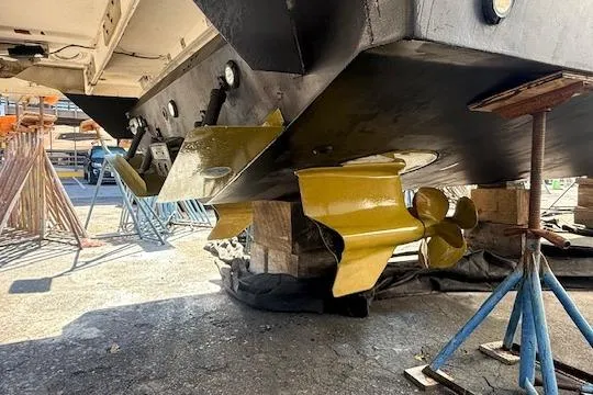 Me Yacht Photos Pics Underside view of 2021 Regal 42 Fly yacht with yellow propellers on stands.