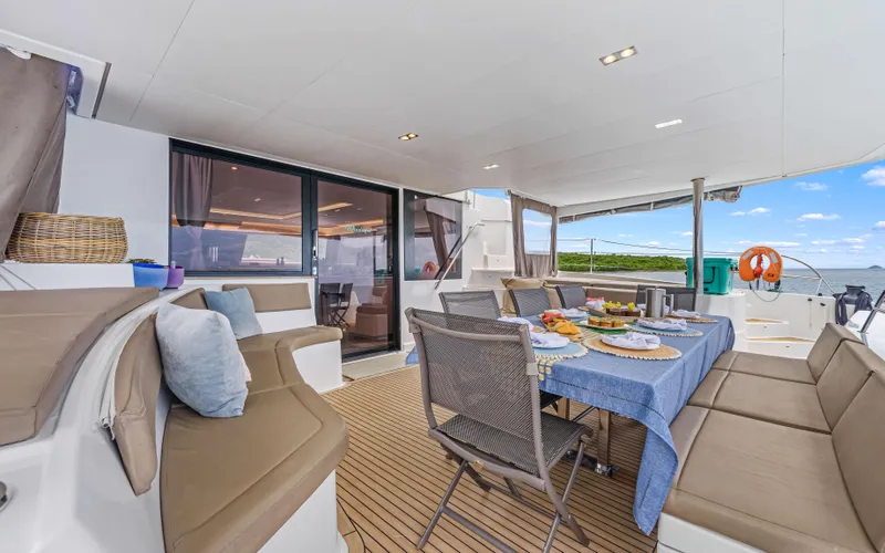 Wonderlust Yacht Photos Pics Luxurious 2016 Fountaine Pajot 72 yacht deck with dining setup and ocean view.