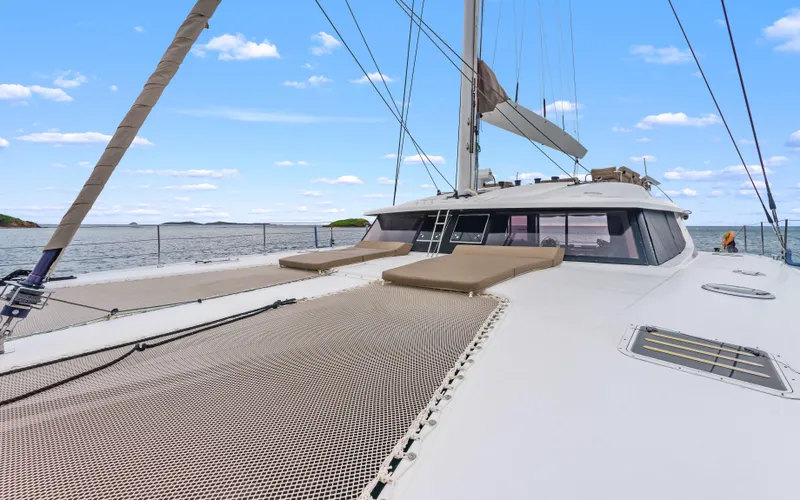 Wonderlust Yacht Photos Pics 2016 Fountaine Pajot 72 catamaran on open water, featuring spacious deck and netting.