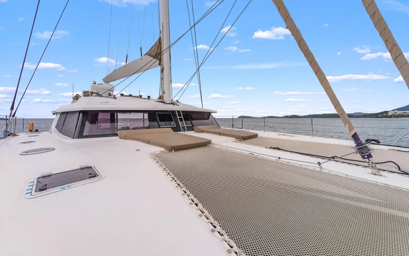 Wonderlust Yacht Photos Pics Fountaine Pajot 72 catamaran deck, 2016 model, with netting and scenic ocean view.