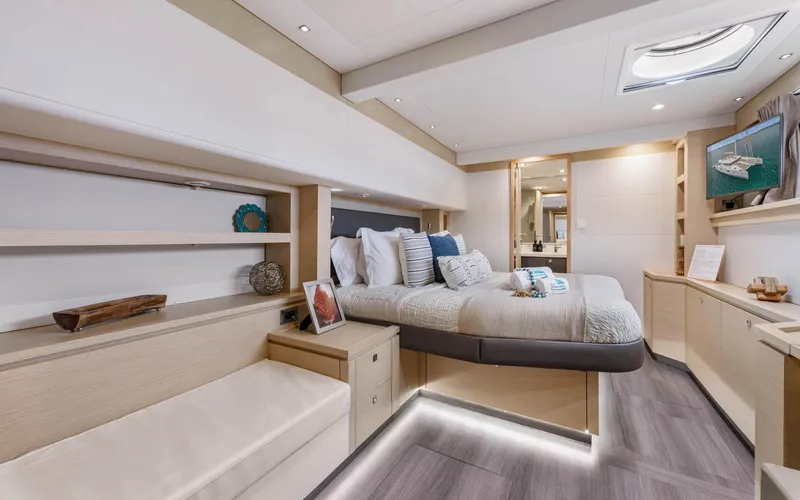Wonderlust Yacht Photos Pics Luxurious cabin interior of 2016 Fountaine Pajot 72 yacht, featuring modern design and cozy bedding.