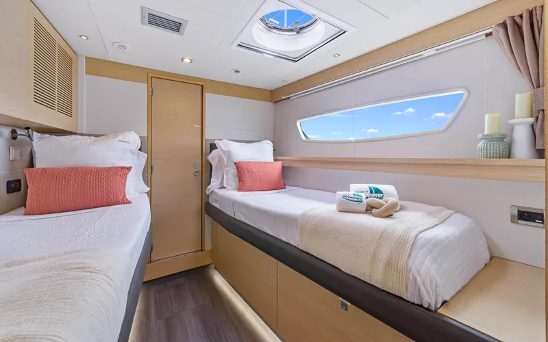 Wonderlust Yacht Photos Pics Luxurious cabin interior of 2016 Fountaine Pajot 72 yacht with twin beds and modern decor.