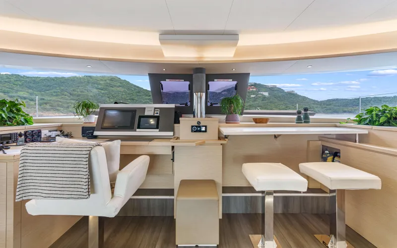 Wonderlust Yacht Photos Pics Luxurious interior of 2016 Fountaine Pajot 72 yacht with modern helm and scenic views.