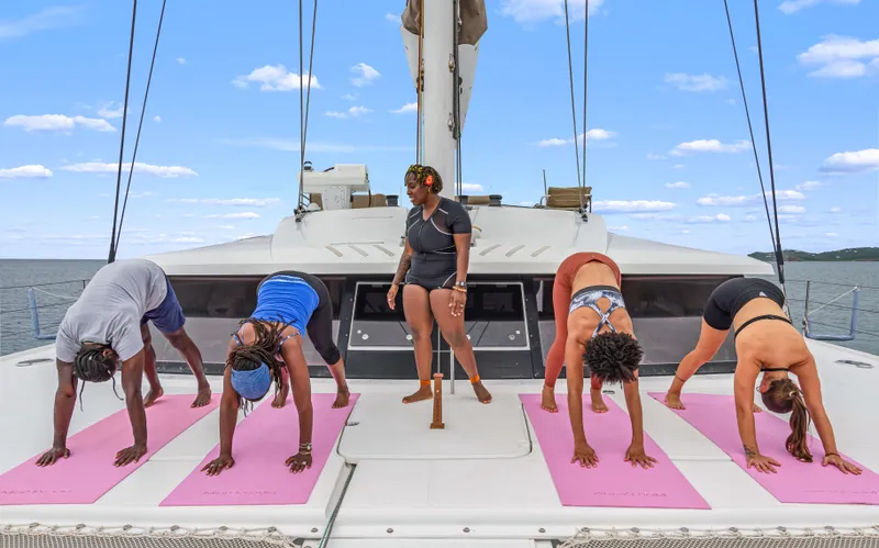 Wonderlust Yacht Photos Pics People practicing yoga on a Fountaine Pajot 72 catamaran deck, 2016 model.