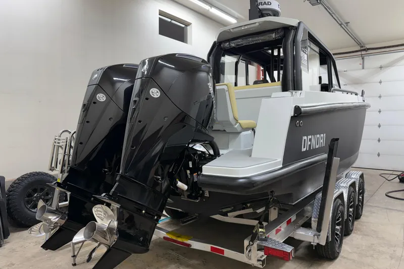 Dfndr1 Yacht Photos Pics 2021 XO Boats DFNDR 9 with dual outboard motors on trailer in garage.