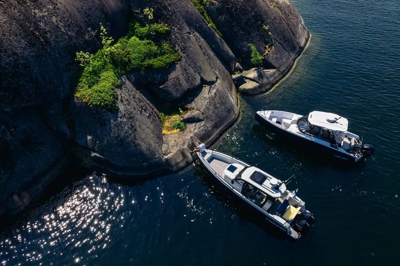 Dfndr1 Yacht Photos Pics 2021 XO Boats DFNDR9 with Trailer near rocky shoreline, aerial view.Dfndr 9 factory image