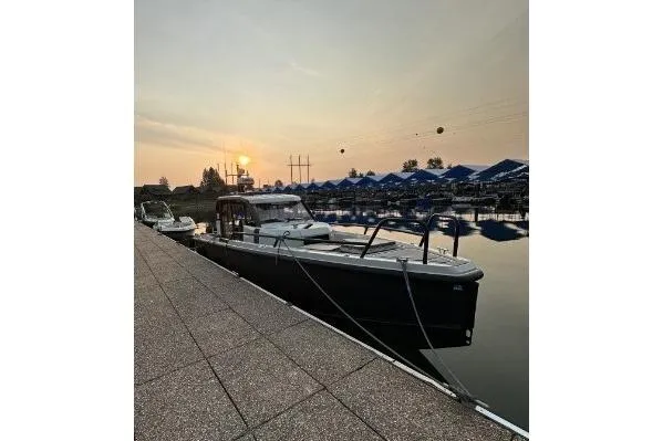 Dfndr1 Yacht Photos Pics 2021 XO Boats DFNDR9 with Trailer docked at sunset, calm waters, scenic view.