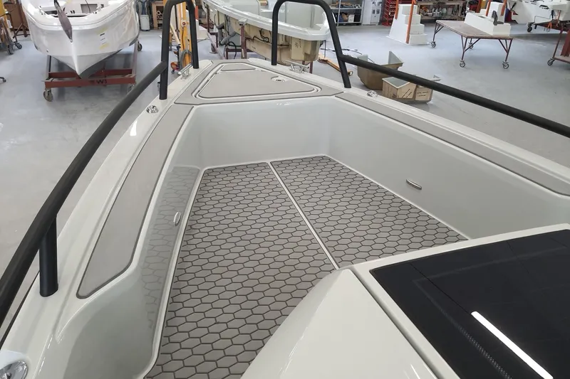 Dfndr1 Yacht Photos Pics 2021 XO Boats DFNDR9 interior with hexagonal flooring in a workshop setting.