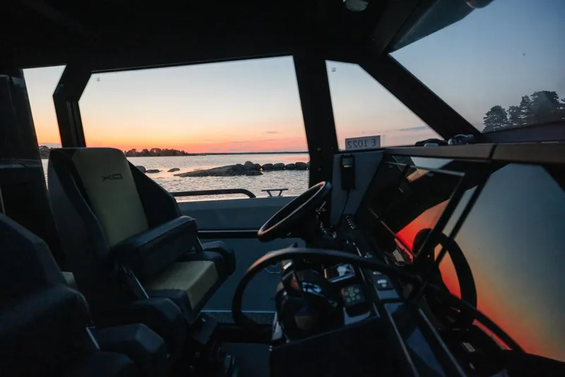 Dfndr1 Yacht Photos Pics Interior view of 2021 XO Boats DFNDR9, showcasing sunset over water through windows.