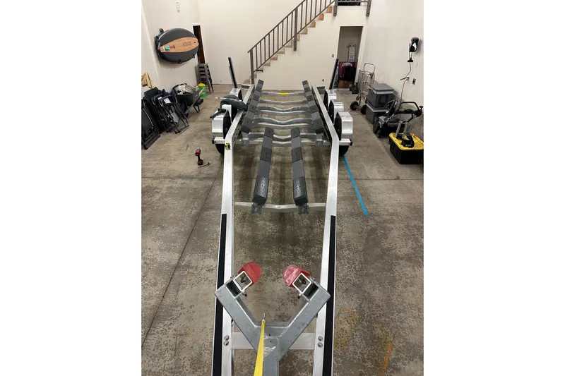 Dfndr1 Yacht Photos Pics 2021 XO Boats DFNDR9 trailer in a garage, showcasing storage and equipment.