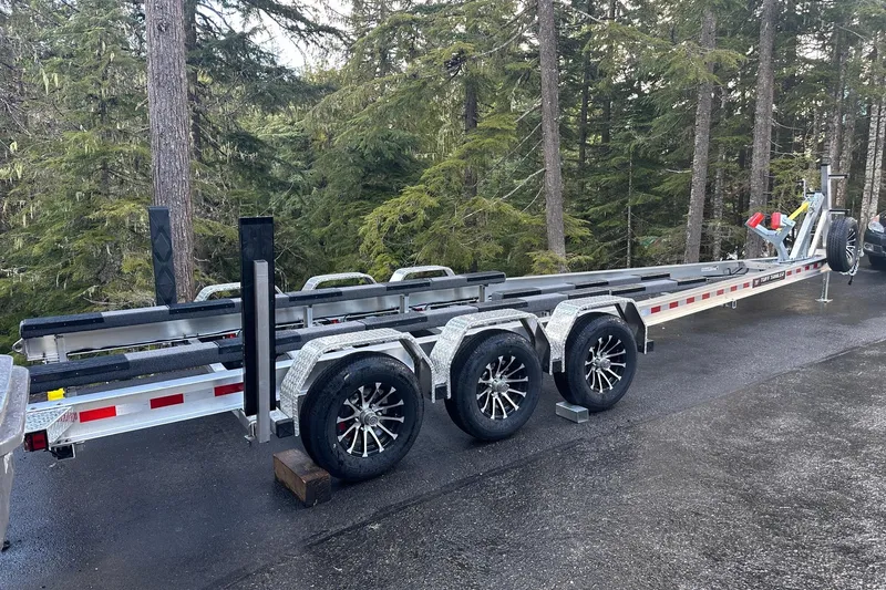 Dfndr1 Yacht Photos Pics 2021 XO Boats DFNDR9 trailer parked in a forested area.