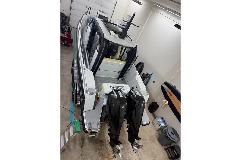 Dfndr1 Yacht Photos Pics 2021 XO Boats DFNDR9 with Trailer in garage, featuring dual outboard motors.