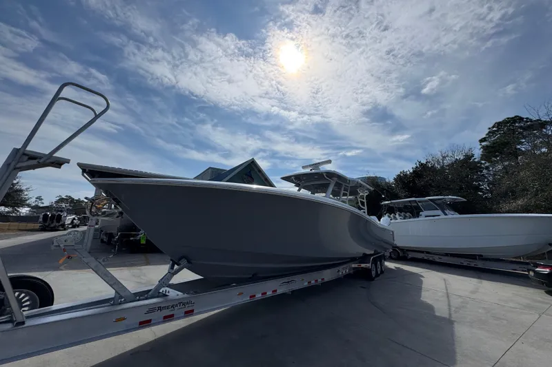  Yacht Photos Pics 2026 Invincible 43 Open Fisherman boat on trailer under sunny sky.