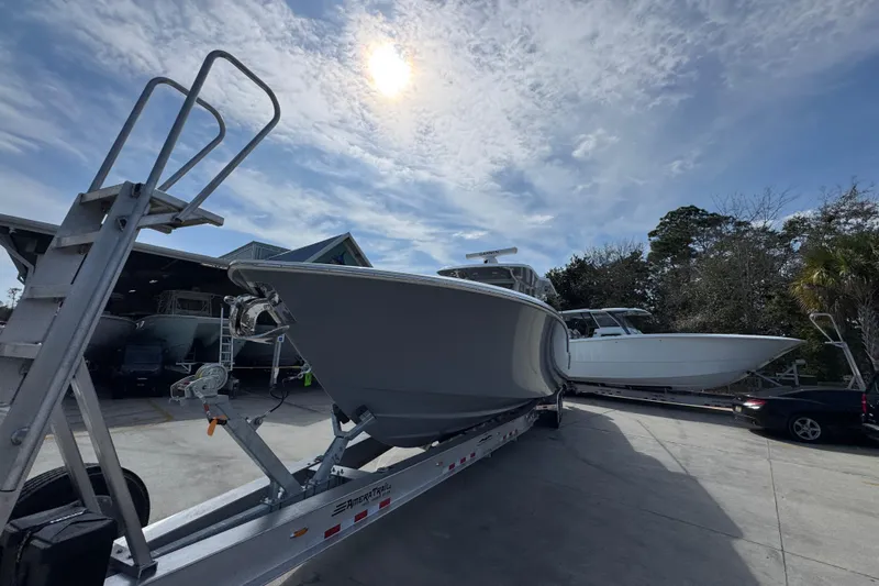  Yacht Photos Pics 2026 Invincible 43 Open Fisherman boat on trailer under sunny sky.