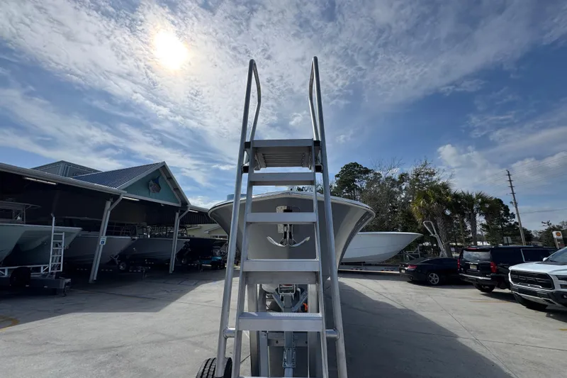  Yacht Photos Pics Ladder leading to Invincible 43 Open Fisherman boat, 2026 model, under a sunny sky.