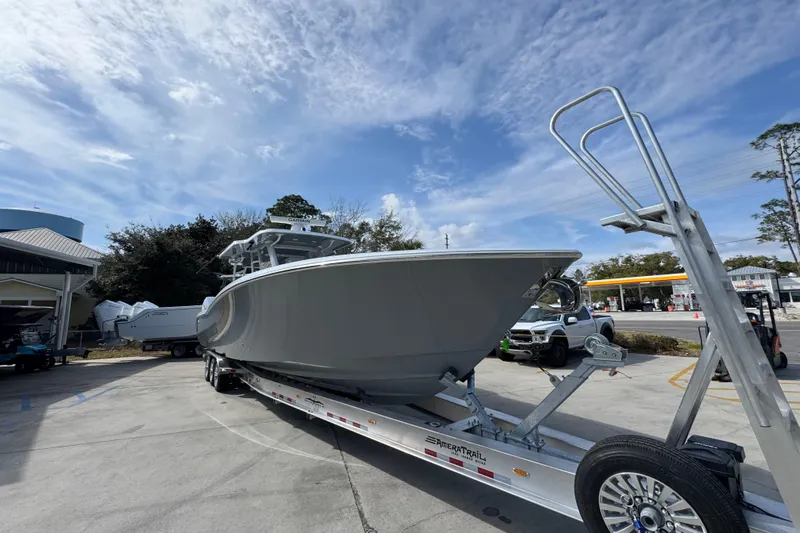  Yacht Photos Pics 2026 Invincible 43 Open Fisherman boat on trailer under blue sky.