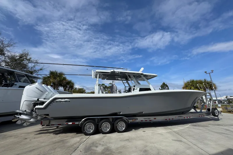  Yacht Photos Pics 2026 Invincible 43 Open Fisherman boat on trailer under blue sky.