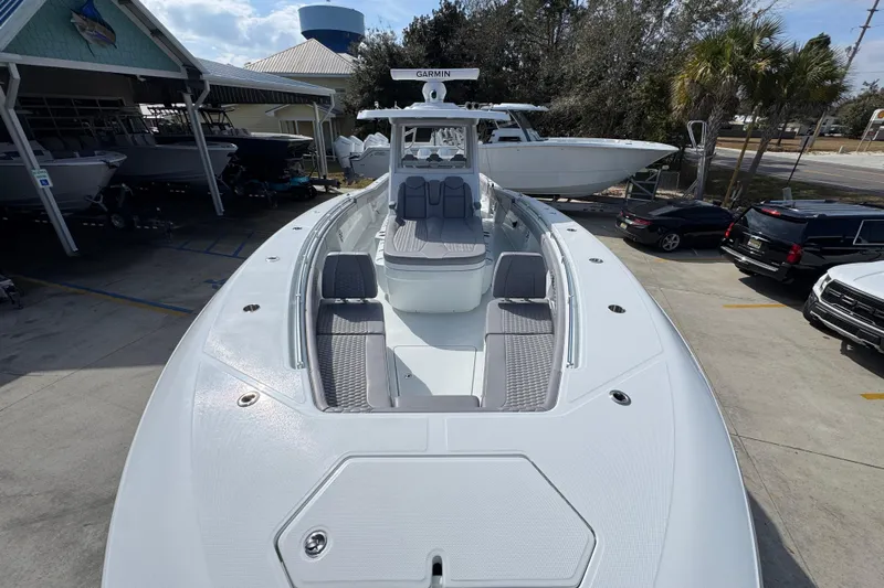  Yacht Photos Pics 2026 Invincible 43 Open Fisherman boat in marina, showcasing sleek design and spacious deck.