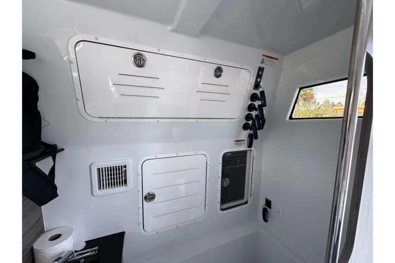  Yacht Photos Pics Interior of 2026 Invincible 43 Open Fisherman boat, featuring storage compartments and control panel.