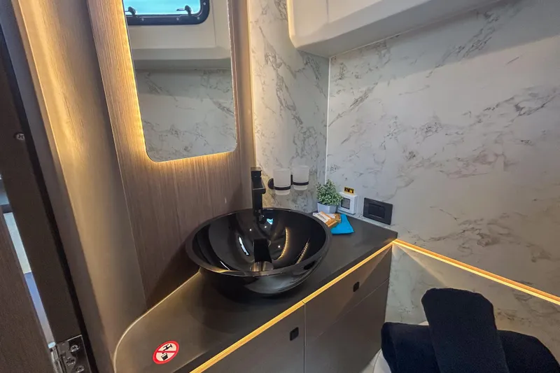 Yacht Photos Pics Luxurious bathroom interior of 2026 Beneteau Gran Turismo 35 yacht with modern fixtures.