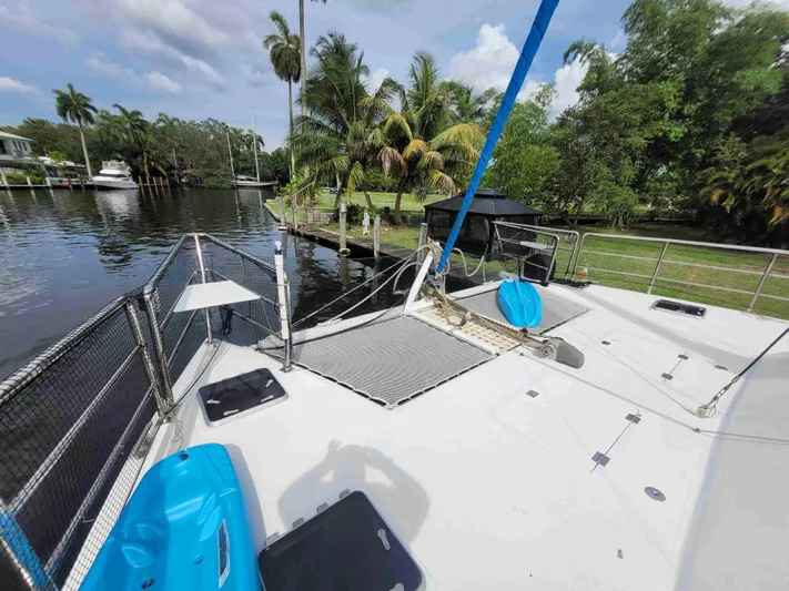 Stella Maris Yacht Photos Pics Custom 50 Len Jenkins boat docked by a lush, tropical riverside in 2016.