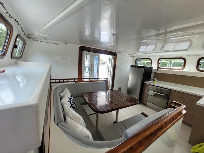 Stella Maris Yacht Photos Pics Interior of 2016 Custom 50 Len Jenkins boat with kitchen and dining area.