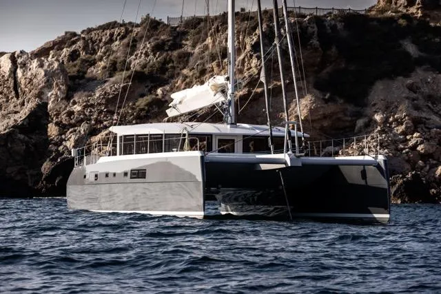  Yacht Photos Pics Luxury Eyecat 55 Autumn catamaran sailing near rocky coastline, 2024 model.