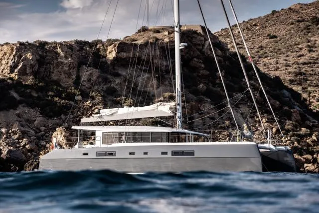  Yacht Photos Pics Luxurious 2024 Eyecat 55 Autumn yacht sailing near rocky coastline.