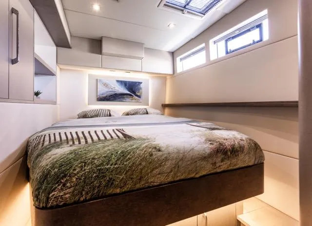  Yacht Photos Pics Luxurious bedroom interior in 2024 Eyecat 55 Autumn yacht, featuring modern design and natural light.