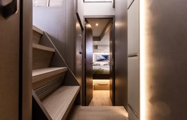  Yacht Photos Pics Modern interior of 2024 Eyecat 55 Autumn yacht with sleek stairs and cozy bedroom.
