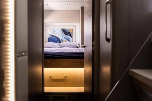  Yacht Photos Pics Luxurious bedroom interior in 2024 Eyecat 55 Autumn yacht, featuring modern design and ambient lighting.