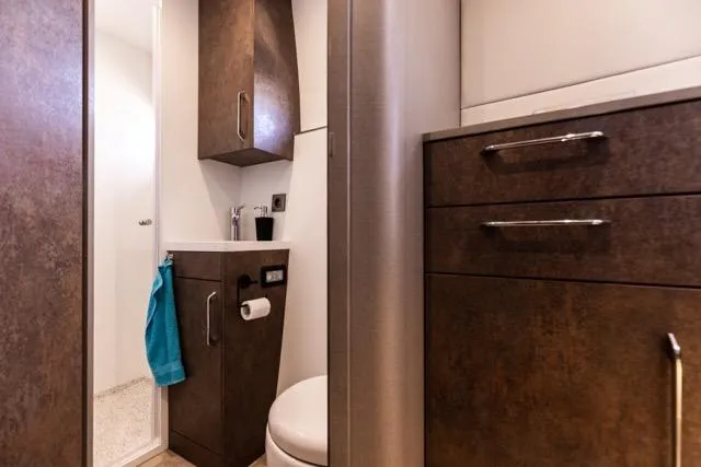  Yacht Photos Pics Compact bathroom in 2024 Eyecat 55 Autumn model with modern wood cabinetry.