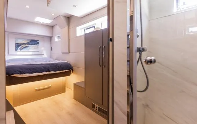  Yacht Photos Pics Luxurious bedroom and bathroom in 2024 Eyecat 55 Autumn yacht, featuring modern design.