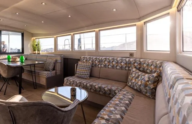  Yacht Photos Pics Luxurious interior of 2024 Eyecat 55 Autumn yacht with modern seating and dining area.