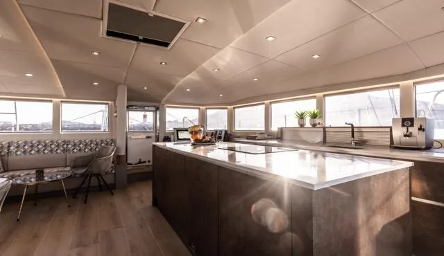  Yacht Photos Pics Luxurious interior of 2024 Eyecat 55 Autumn yacht with modern kitchen and seating area.