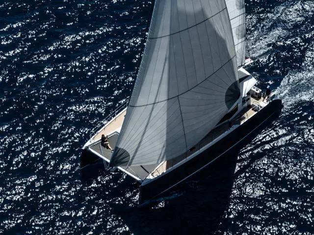  Yacht Photos Pics Aerial view of Eyecat 55 Autumn 2024 sailing on deep blue ocean waters.