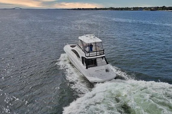  Yacht Photos Pics 2008 Sea Ray 47 Sedan Bridge cruising on open water at sunset.