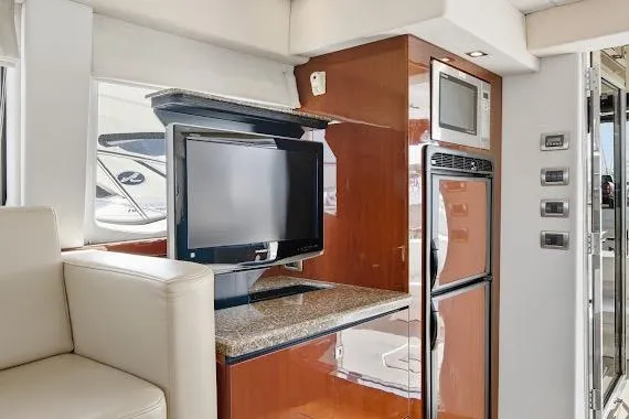  Yacht Photos Pics Interior of 2008 Sea Ray 47 Sedan Bridge with TV, microwave, and fridge.