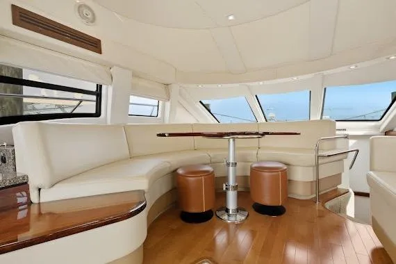  Yacht Photos Pics Luxurious interior of 2008 Sea Ray 47 Sedan Bridge yacht with elegant seating and panoramic windows.