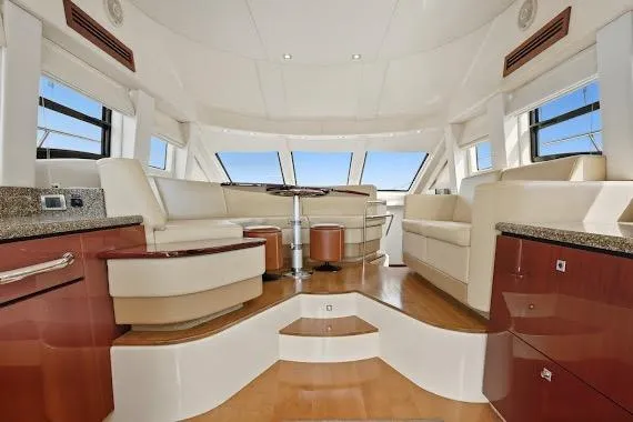  Yacht Photos Pics Luxurious interior of 2008 Sea Ray 47 Sedan Bridge yacht with elegant seating and panoramic windows.