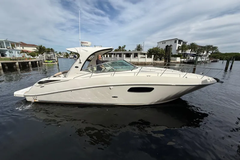  Yacht Photos Pics 2012 Sea Ray 370 Sundancer yacht cruising in a scenic waterfront setting.