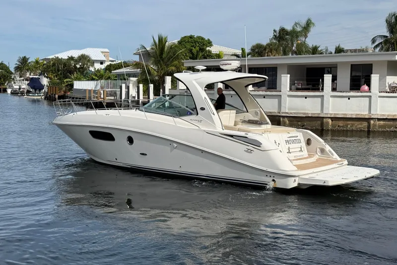  Yacht Photos Pics 2012 Sea Ray 370 Sundancer yacht cruising on a calm waterway.