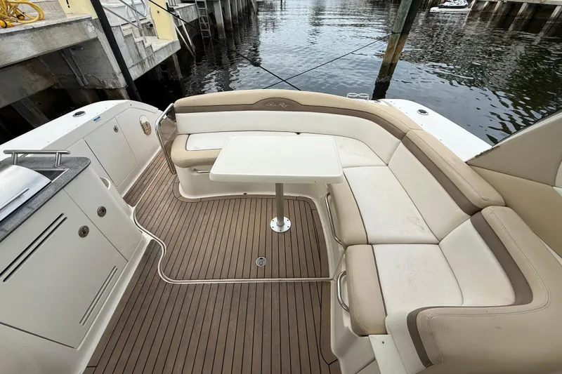  Yacht Photos Pics Luxurious 2012 Sea Ray 370 Sundancer boat interior with seating and table by the water.