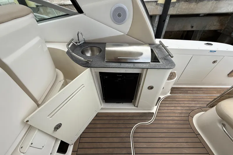  Yacht Photos Pics 2012 Sea Ray 370 Sundancer yacht kitchenette with sink, grill, and storage.