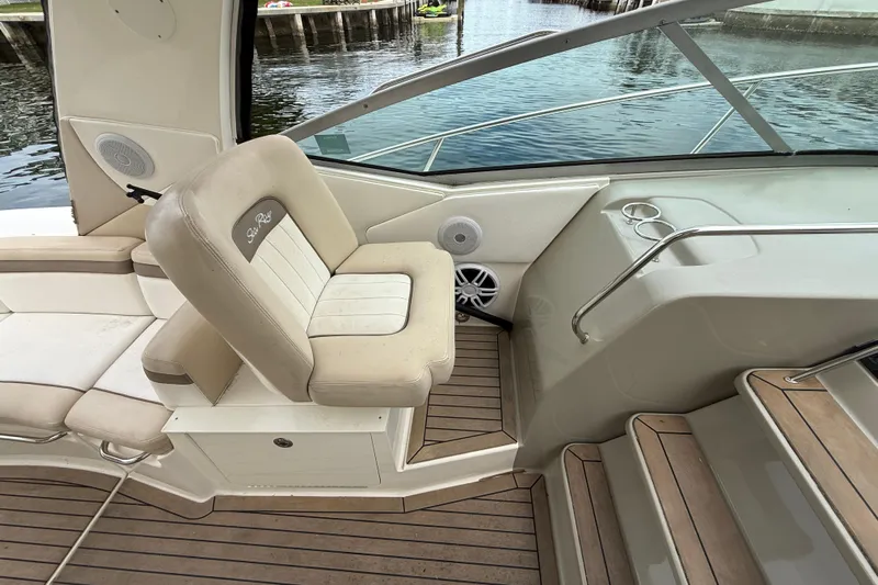  Yacht Photos Pics 2012 Sea Ray 370 Sundancer cockpit with beige seating and wooden flooring by the water.
