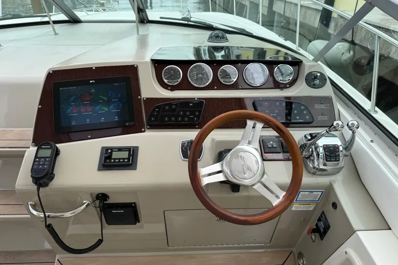  Yacht Photos Pics 2012 Sea Ray 370 Sundancer helm with modern controls and wooden steering wheel.