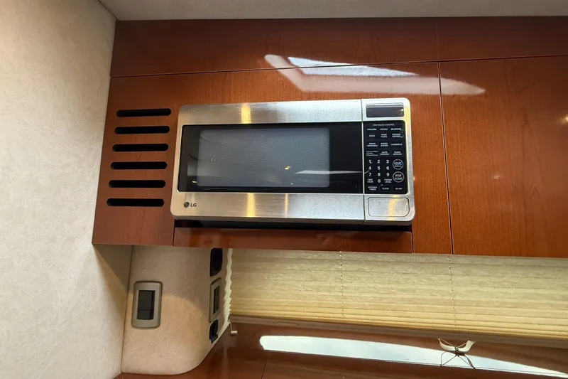  Yacht Photos Pics LG microwave in 2012 Sea Ray 370 Sundancer yacht's wooden interior kitchen.
