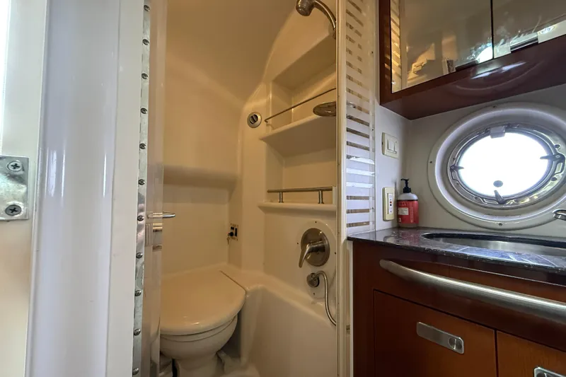 Yacht Photos Pics Bathroom interior of 2012 Sea Ray 370 Sundancer yacht with shower and porthole window.